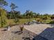 Charming brick patio with seating area, surrounded by tropical plants at 4251 Oak Terrace Cir, Port Charlotte, FL 33953