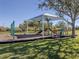 playground with shaded play structure and swings at 4251 Oak Terrace Cir, Port Charlotte, FL 33953