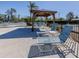 Relax and unwind by the pool with comfortable lounge chairs and a shaded gazebo at 4251 Oak Terrace Cir, Port Charlotte, FL 33953