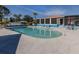 Community pool with lounge chairs and shaded seating area at 4251 Oak Terrace Cir, Port Charlotte, FL 33953