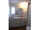 Clean bathroom with white vanity, shower, and window at 426 Boxwood Dr, Venice, FL 34285