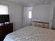 Main bedroom with TV, dresser and access to exterior door at 426 Boxwood Dr, Venice, FL 34285