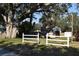 Spacious backyard with a shed and white fence at 451 Home Park Rd, Venice, FL 34285