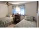 Guest bedroom with two twin beds and a ceiling fan at 451 Home Park Rd, Venice, FL 34285