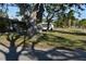 Landscaped yard with large shade trees at 451 Home Park Rd, Venice, FL 34285