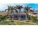 Backyard oasis with pool, palm trees, and lush landscaping at 4621 Gaeta Dr, Venice, FL 34293