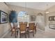Elegant dining room with a wooden table and wicker chairs, near the entryway at 4621 Gaeta Dr, Venice, FL 34293