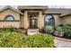 Landscaped front yard with palm tree and walkway to entryway at 4621 Gaeta Dr, Venice, FL 34293