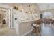 White kitchen with breakfast bar and view into dining room at 4621 Gaeta Dr, Venice, FL 34293