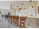 Modern kitchen with white cabinets, breakfast bar, and tile flooring at 4621 Gaeta Dr, Venice, FL 34293
