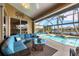 L-shaped sectional sofa and glass coffee table on patio overlooking pool at 4621 Gaeta Dr, Venice, FL 34293