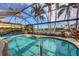 Kidney shaped pool with screened enclosure, overlooking a lake at 4621 Gaeta Dr, Venice, FL 34293