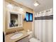 Bathroom with granite vanity and shower with curtain at 500 Park S Blvd # 7, Venice, FL 34285