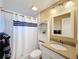 Clean bathroom with shower/tub combo, vanity, and linen storage at 500 Park S Blvd # 7, Venice, FL 34285