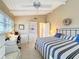 Bedroom with striped bedding and built-in desk and shelving at 500 Park S Blvd # 7, Venice, FL 34285