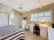 Bedroom with striped bedding, built-in desk and white closet at 500 Park S Blvd # 7, Venice, FL 34285