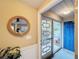 Bright entryway with a rope mirror and blue door leading outside at 500 Park S Blvd # 7, Venice, FL 34285