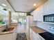 White kitchen with breakfast bar and view into living room at 500 Park S Blvd # 7, Venice, FL 34285