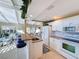 Open kitchen with breakfast bar and view into living room at 500 Park S Blvd # 7, Venice, FL 34285