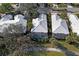 An aerial view of a home with a screened-in pool and lush landscaping at 522 Fallbrook Dr, Venice, FL 34292