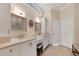 Bright bathroom featuring double sinks, vanity and plenty of storage at 522 Fallbrook Dr, Venice, FL 34292