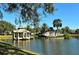 Scenic view of the Venice Golf and Country Club entrance with a gazebo on the water at 522 Fallbrook Dr, Venice, FL 34292
