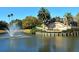 Picturesque entrance to Venice Golf and Country Club with lush landscaping and a tranquil lake at 522 Fallbrook Dr, Venice, FL 34292