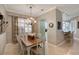 Dining room with chandelier and shutters, next to the kitchen and breakfast bar at 522 Fallbrook Dr, Venice, FL 34292
