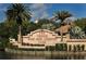 Landscaped Venice Golf and Country Club entrance sign at the lake with palm trees and beautiful plants at 522 Fallbrook Dr, Venice, FL 34292