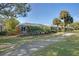 Back exterior view of the house features screened-in patio, pool, landscaping, and golf course at 522 Fallbrook Dr, Venice, FL 34292