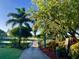 View of the beautiful Venice Golf and Country Club golf course with lush greens and wooden bridge at 522 Fallbrook Dr, Venice, FL 34292