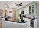 Well-lit kitchen features a breakfast bar, stainless steel appliances, and granite countertops at 522 Fallbrook Dr, Venice, FL 34292
