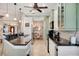 Bright kitchen with stainless appliances, granite countertops, and a view to the dining room at 522 Fallbrook Dr, Venice, FL 34292
