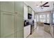 Spacious kitchen with white cabinets, stainless steel appliances, black counters, and tiled floors at 522 Fallbrook Dr, Venice, FL 34292