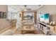 Cozy living room with an island, neutral furnishings, and views of the lush backyard at 522 Fallbrook Dr, Venice, FL 34292