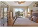 Comfortable main bedroom showcasing natural light with an ensuite bath and golf course views at 522 Fallbrook Dr, Venice, FL 34292