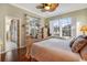 Well-lit main bedroom offering a tranquil retreat with ensuite bath and a view of the lanai and golf course at 522 Fallbrook Dr, Venice, FL 34292