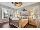 Spacious main bedroom with a decorative ceiling fan, hardwood floors, and plentiful natural light at 522 Fallbrook Dr, Venice, FL 34292