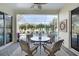 A cozy screened-in patio features comfortable seating and a lovely view of the refreshing pool and lush landscaping at 522 Fallbrook Dr, Venice, FL 34292