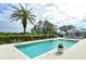Enjoy this community pool with chairs, umbrellas, and beautiful plants at the Venice Golf and Country Club at 522 Fallbrook Dr, Venice, FL 34292