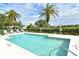 Inviting community pool featuring crystal-clear water, comfortable lounge chairs, and well-maintained landscaping at 522 Fallbrook Dr, Venice, FL 34292
