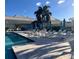 Poolside with comfortable lounge chairs and umbrellas, perfect for relaxation at 522 Fallbrook Dr, Venice, FL 34292