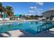 Inviting swimming pool with clear blue water and lounge chairs under bright skies at 522 Fallbrook Dr, Venice, FL 34292