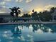 Beautiful swimming pool at sunset with clear water and inviting lounge area at 522 Fallbrook Dr, Venice, FL 34292