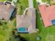 Aerial view of the home featuring a private screened-in pool, tile roof, and well-manicured landscaping at 523 Park Estates Sq, Venice, FL 34293
