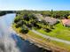 Aerial view of a quiet neighborhood by the lake with walking path and green space at 523 Park Estates Sq, Venice, FL 34293