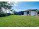 Expansive backyard with lush lawn and a screened-in patio, perfect for relaxation at 523 Park Estates Sq, Venice, FL 34293