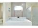 Bathroom featuring a large bathtub, a separate shower, and a frosted window at 523 Park Estates Sq, Venice, FL 34293