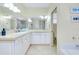 Bright bathroom with double sinks, vanity, and a large mirror at 523 Park Estates Sq, Venice, FL 34293