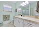 Bright bathroom with a single sink, vanity, and a sliding glass shower door at 523 Park Estates Sq, Venice, FL 34293